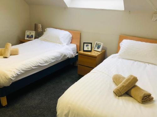 a bedroom with two beds with stuffed animals on them at Bonnygate in Fife