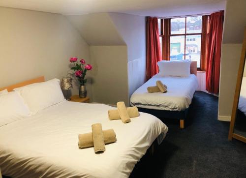 two beds with towels on them in a room at Bonnygate in Fife