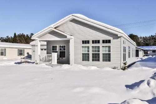 a white house with snow in front of it at Base Camp Eagle River in Eagle River