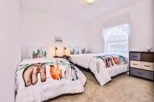 a bedroom with two beds with animals on them at Base Camp Eagle River in Eagle River