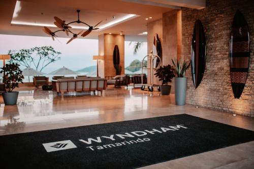 a lobby with a black rug on the floor at Wyndham Tamarindo in Tamarindo