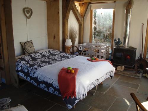 a bedroom with a bed with fruit on it at The Barn - Located away from people! in Swanage