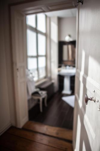 a hallway with a room with a desk and a window at Bienvenue Chez Nous in Bergues