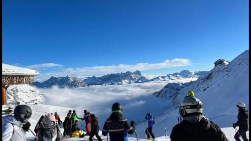 a group of people standing on top of a snow covered mountain at Fedaia Joy B&B in Canazei