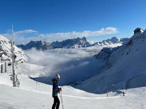 a person on skis standing on a snow covered mountain at Fedaia Joy B&B in Canazei