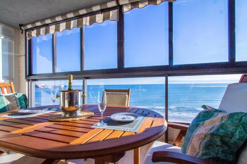 a dining room table with a view of the ocean at ESPACIO 16 - Primera LINEA PLAYA in Cullera