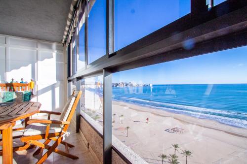 a balcony with a view of the beach and the ocean at ESPACIO 16 - Primera LINEA PLAYA in Cullera