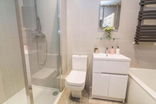 a bathroom with a toilet and a shower and a sink at 4 Bed House Mapperley walking distance to city centre Nottingham sleeps 8 in Nottingham
