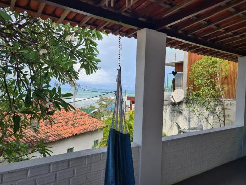 a hammock hanging on a porch with a view at Casa de Dan in Pipa