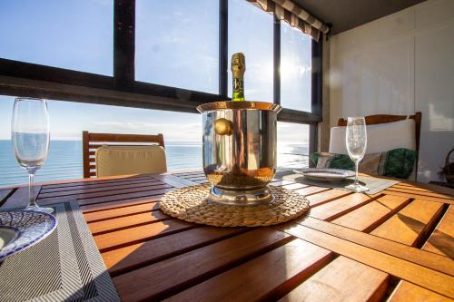 a bottle of wine in a container on a wooden table at ESPACIO 16 - Primera LINEA PLAYA in Cullera