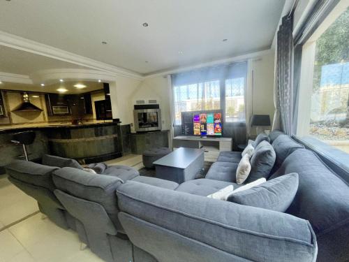 a large living room with a large blue couch at DREAM VILLA IN ALBIR BLUELINE in L'Alfas del Pi