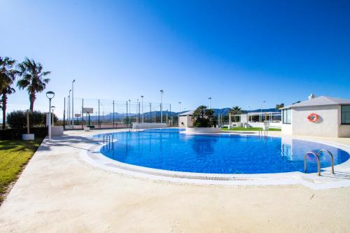 a large swimming pool with blue water at ESPACIO 16 - Primera LINEA PLAYA in Cullera