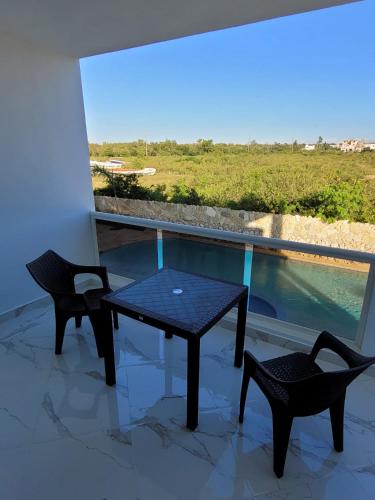 a table and two chairs on a balcony with a view at CASA MARAVILLOSA in Bayahibe