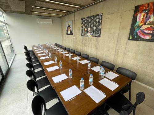 a conference room with a long wooden table and chairs at The Stay Furnished Apartments in Dbayeh