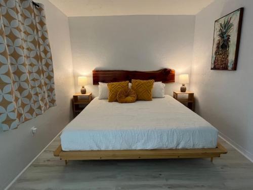 a bedroom with a large bed with two lamps at Retro motel walk to beach, Wi-Fi in Daytona Beach