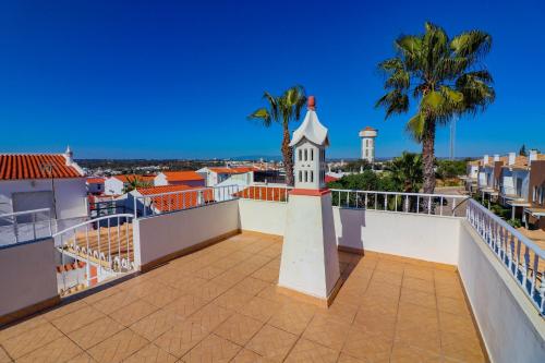 a view from the roof of a building with a clock tower at Cantinho do Mocho in Pêra