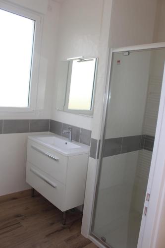 a bathroom with a sink and a shower at La Baraque in Gourhel