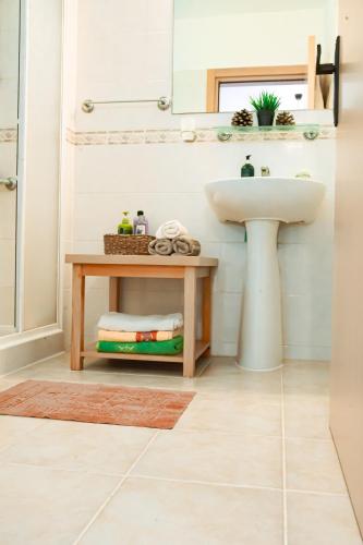 a bathroom with a sink and a table at Fantastic 4 Cyprus First Line Beachfront in Boghaz