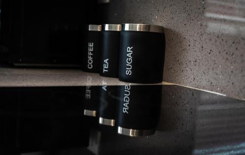 a couple of cups sitting on a counter at Woodley house in Reading