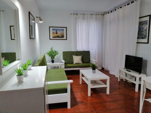 a living room with a couch and a table at Casa Alisios in Playa de Santiago