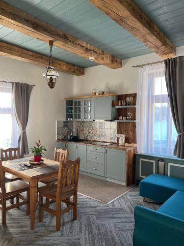 a kitchen and dining room with a table and chairs at Vila Liberta in Poprad