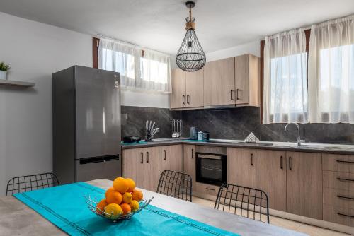 a kitchen with a table with a bowl of oranges on it at Mayas House Greece Rhodes Kremasti in Kremasti