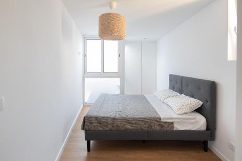 Ένα ή περισσότερα κρεβάτια σε δωμάτιο στο Echo Homespaces Marquês