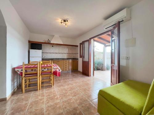 a kitchen and dining room with a table and chairs at Can Pep Yern 2 in Playa Migjorn