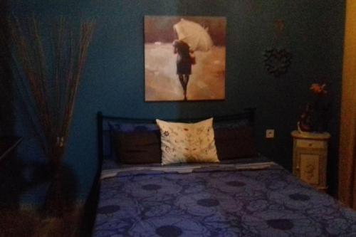 sypialnia z łóżkiem z obrazem na ścianie w obiekcie D&S home oinofita w mieście Oinófita