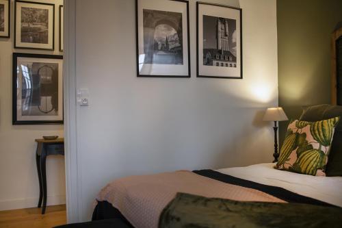 a bedroom with a bed with pictures on the wall at Bienvenue Chez Nous in Bergues