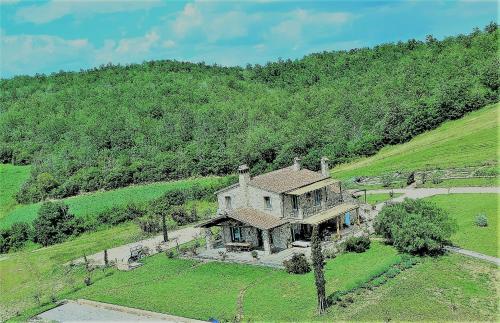 an aerial view of a house on a hill at montecristo country house in Marsiliana