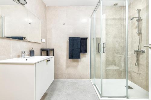 a bathroom with a glass shower and a sink at Sweet garden Las palmas in Las Palmas de Gran Canaria