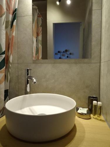 a white sink in a bathroom with a mirror at La Méridienne - Chambres d'hôtes in Venterol