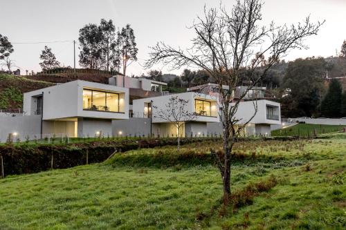 a house on top of a hill with a tree at Viana do Castelo - Amonde Village - Casa L - Disfrute da Natureza in Amonde