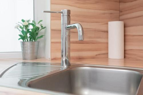 a kitchen sink with a faucet on a counter at Danube Art Apartments in Vienna
