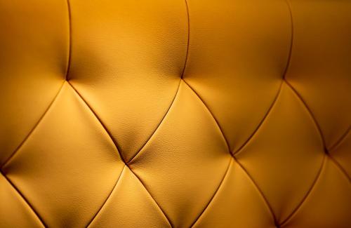 an image of the back of an orange leather couch at Palatinus Boutique Hotel in Pécs