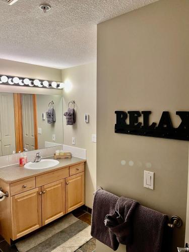 a bathroom with a sink and a mirror at Wanna get away next Summer and Fall at the Crossing in Canmore