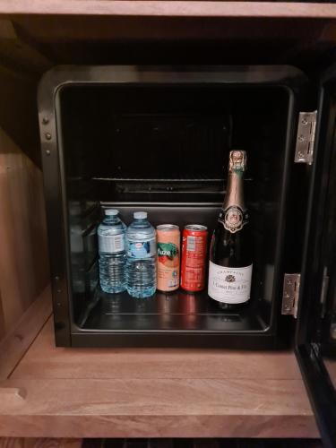 a bottle of beer and bottles of water in a toaster oven at LOVE ROOM - Luxembourg in Luxembourg