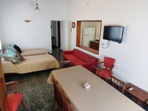 a room with a living room with a bed and a couch at La Porota in Ramallo