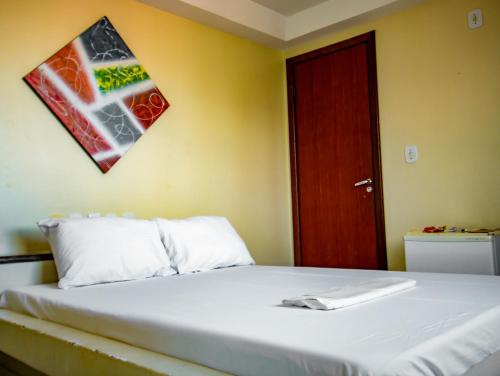 a bedroom with a bed and a red door at Hotel Piramide Pituba - Av Paulo VI in Salvador