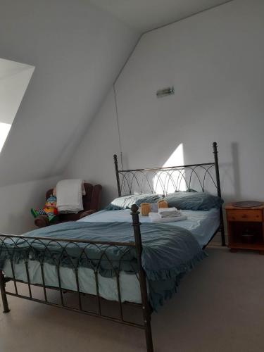 a bedroom with a bed in a white room at Guest House - oxfordshire in Banbury