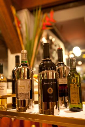 a group of bottles of wine sitting on a shelf at Antara Hotel & Suites - Miraflores in Lima