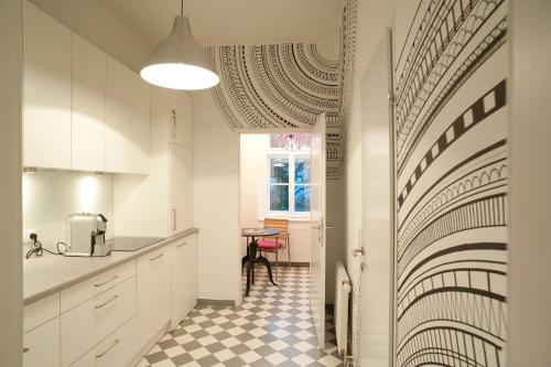 a kitchen with a black and white checkered floor at Yppartment in Vienna