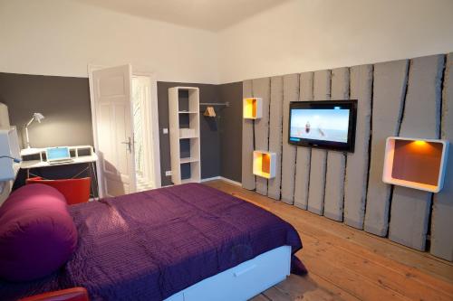 a bedroom with a bed and a tv on a wall at Yppartment in Vienna