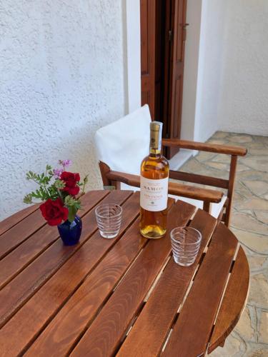 a bottle of whiskey sitting on a wooden table at Gaia Apartments By Villa Kokkoni in Marathokampos