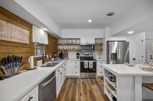 a kitchen with white cabinets and stainless steel appliances at Seabrook 3BR Near Kemah Boardwalk, El Jardin Beach in Seabrook