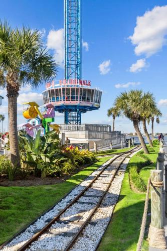 a set of train tracks in front of a roller coaster at Seabrook 3BR Near Kemah Boardwalk, El Jardin Beach in Seabrook