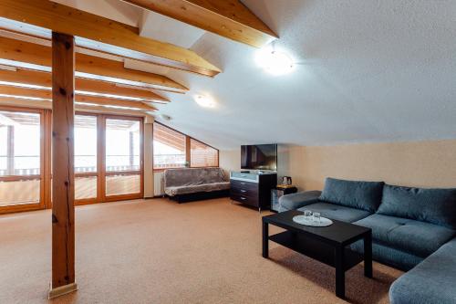 a living room with a couch and a table at Orava Hotel in Vitanová