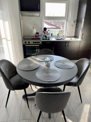 a table and chairs in a kitchen with a table at Welcome to Bucharest Airport Residences & Therme-SELF CHECK-IN in Otopeni