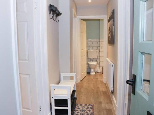 a hallway with a bathroom with a toilet and a door at Divine, detached countryside cottage near Ludlow. in Ludlow
